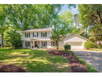 Charming two-story home with mature trees, attached garage, and a well-manicured lawn at 3101 Willowbrae Rd, Charlotte, NC 28226