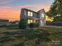 Charming two-story home with a well-manicured lawn and inviting front porch, perfect for relaxing evenings at 417 Homestead Ln, Albemarle, NC 28001