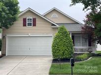 Charming home featuring a white garage door and a cozy front porch with a white picket fence at 422 Garnet Ct, Fort Mill, SC 29708
