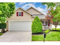 Charming home featuring a two-car garage and well-manicured lawn with mature trees, offering great curb appeal at 422 Garnet Ct, Fort Mill, SC 29708