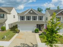 Charming two-story home with a two-car garage, landscaped front yard, and welcoming facade at 509 Silers Bald Dr, Fort Mill, SC 29715
