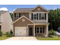 Charming two-story home featuring a one-car garage and welcoming front porch at 6717 Ware Rd, Charlotte, NC 28212