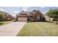 Charming single-Gathering home boasts manicured lawn and a two-car garage, creating an inviting curb appeal at 9026 Raven Top Dr, Mint Hill, NC 28227