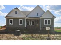 Charming craftsman style home with mixed siding and brick accents and covered entryway at Lot 101 Coppergate Dr, Salisbury, NC 28147