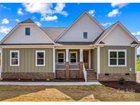 Charming home with a welcoming front porch, manicured landscaping, and a combination of siding and brick accents at Lot 101 Coppergate Dr, Salisbury, NC 28147