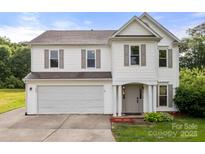 Charming two-story home with a two car garage, neutral siding, and well manicured landscaping at 100 Brookstone Dr, Mount Holly, NC 28120