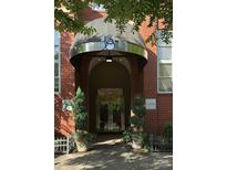 Exterior of brick building featuring covered entrance and stainless steel doors, complemented by decorative planters at 1320 Fillmore Ave, Charlotte, NC 28203