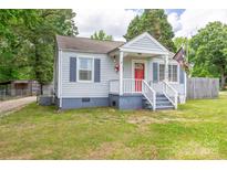 Charming single-story home with a quaint front porch and red front door at 1415 Midlake Rd, Kannapolis, NC 28083