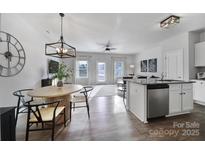 Bright, open concept living room and kitchen area with stainless steel appliances and a dining area with seating at 177 Briana Marie Way, Indian Trail, NC 28079