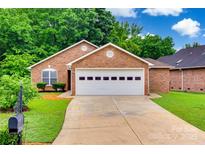 Charming single-story brick home featuring a two-car garage and well-maintained landscaping at 1866 Charter Dr, Rock Hill, SC 29732