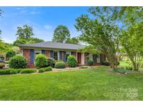 Charming brick ranch home with manicured lawn and mature trees at 1940 12Th Ne St, Hickory, NC 28601