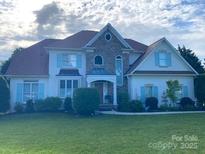 Charming two-story home with stone accents, inviting entrance and well-manicured lawn at 21216 Norman Shores Dr, Cornelius, NC 28031