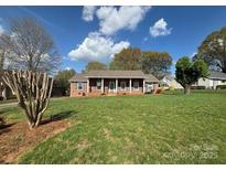Charming brick home with a well-manicured lawn and mature trees at 3660 9Th Street Ne Dr, Hickory, NC 28601