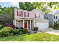 Charming two-story home with red shutters, manicured lawn, and two-car garage at 3915 Planters Watch Dr, Charlotte, NC 28278