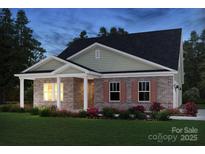 Charming brick home with a covered porch and beautiful landscaping at 407 Bent Burr Crk, York, SC 29745
