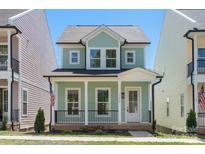 Charming two-story home with a welcoming front porch and beautiful curb appeal at 5820 Pittmon Ln, Kannapolis, NC 28081