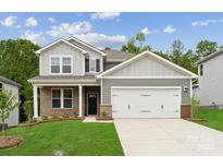 Charming two-story home with a mix of brick and gray siding, complemented by a well-manicured lawn at 9952 Manor Vista Trl, Kannapolis, NC 28027