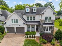 Beautiful two-story home featuring a stone and siding facade, dormer windows, and a two-car garage at 1012 N Sharon Amity Rd, Charlotte, NC 28211