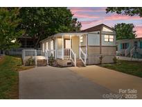 Charming home with a welcoming front porch, a side deck, and a spacious driveway at 165 Cardinal Dr # 615, New London, NC 27371