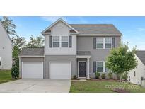 Charming two-story home featuring a two-car garage, gray siding, shutters, and a well-manicured front lawn at 165 Clove Hitch Dr # I281, Statesville, NC 28677