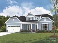Charming two-story home featuring a blue exterior, white trim, a covered porch, and an attached two-car garage at 1721 Tabby Dr # Cal0062, Indian Trail, NC 28079