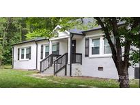 Charming, newly renovated single-story home with a white brick exterior and well-maintained front yard at 2376 S Us 321 Hwy, Newton, NC 28658
