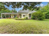 Charming home with a covered carport, complemented by mature trees and vibrant landscaping at 2556 Salem Church Rd, Lincolnton, NC 28092