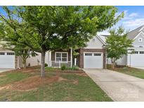 Charming brick home with an attached garage, a lovely landscaped yard, and welcoming curb appeal at 5076 Newport Lakes Dr, Rock Hill, SC 29732