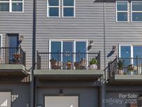 A stylish balcony features a seating area with a small table, perfect for relaxing outdoors at 5512 Swaling St, Charlotte, NC 28217