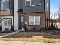 Charming townhome featuring brick accents and a stylish dark-colored front door at 5524 Swaling St, Charlotte, NC 28217