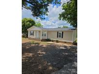 Charming single-story home with a covered front porch and gravel driveway at 6006 White Store Rd, Marshville, NC 28103