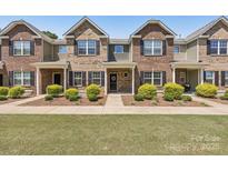 Charming townhome with brick facade, black shutters, manicured landscaping, and a welcoming entrance at 6315 Prosperity Church Rd, Charlotte, NC 28269