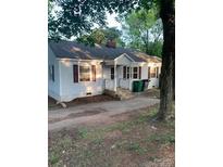 Charming single-story home with light colored exterior and ample front yard space at 104 Willetta Dr, Charlotte, NC 28217