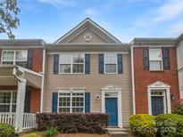 Charming townhome with a well-maintained facade, featuring blue shutters and a quaint front garden at 14056 Lyon Hill Ln, Huntersville, NC 28078