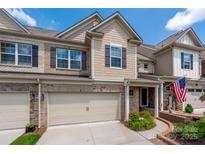 Charming townhome with brick and siding exterior, inviting front entrance and two-car garage at 5014 Forest Hills Pl, Fort Mill, SC 29707