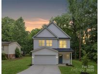 Charming two-story home featuring white siding, attached garage and a welcoming front porch at 515 Dixie Dr, Mooresville, NC 28115