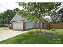 Charming exterior of a single-Gathering home with a well-manicured lawn and attached garage at 9051 Country Barn Ct, Charlotte, NC 28273