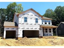 New two-story home featuring an attached two-car garage, covered porch, and large windows at 9945 Cask Way, Huntersville, NC 28078