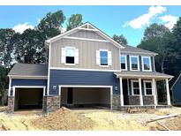 Charming two-story home with a two-car garage and stone accents at 9945 Cask Way, Huntersville, NC 28078