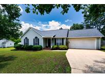 Charming one-story home with a well-manicured lawn and attached two-car garage at 112 Brookshire Dr, Fort Mill, SC 29715