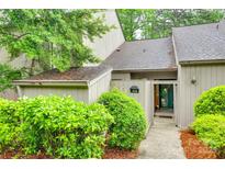 Charming condo featuring neutral tones and a well-maintained exterior with beautiful green landscaping and covered front entry at 115 Pine Grove Cir, Clover, SC 29710