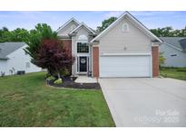 Charming single-Gathering home featuring a well-manicured lawn and an attached two-car garage at 16337 Greybriar Forest Ln, Charlotte, NC 28278