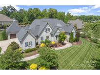 Beautiful home featuring a well-manicured lawn and charming curb appeal with a three car garage at 18207 Shearer Rd, Davidson, NC 28036