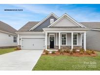 Charming single-Gathering home with a gray exterior, stone accents, attached garage, and well-maintained landscaping at 2043 Skyhawk Dr, York, SC 29745