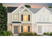 Charming two-story townhome featuring a brick facade, neutral siding, black shutters, and well-manicured landscaping at 2125 Riverstone Blvd # 140, Monroe, NC 28110
