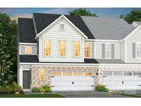 Charming townhouse with brick facade, white garage doors, and varied siding textures at 2215 Cobble Ct # 215, Monroe, NC 28110