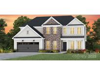 Charming two-story home featuring brick accents, a gray garage door, and a well-manicured lawn at 2218 Riverbend Ave # 23, Monroe, NC 28110