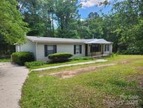 Charming single-story home with a well-maintained lawn and mature trees providing shade at 269 Saddle Rd, Lancaster, SC 29720