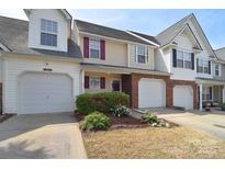 Charming townhome featuring a one-car garage, neutral siding, and well-maintained landscaping, enhancing curb appeal at 3050 Des Prez Ave, Fort Mill, SC 29707