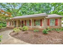 Charming single-story home boasts a well-maintained front yard with mature trees and inviting curb appeal at 3430 Rea Rd, Charlotte, NC 28226